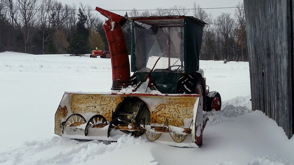 The snow blower attached to the tractor