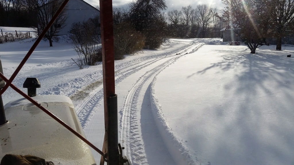 Driveway cleared with snowblower on tractor