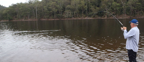 Andy fishing with a light combo at a dam