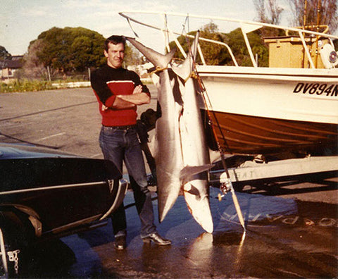 Andy with two sharks freshly caught and his Pontiac