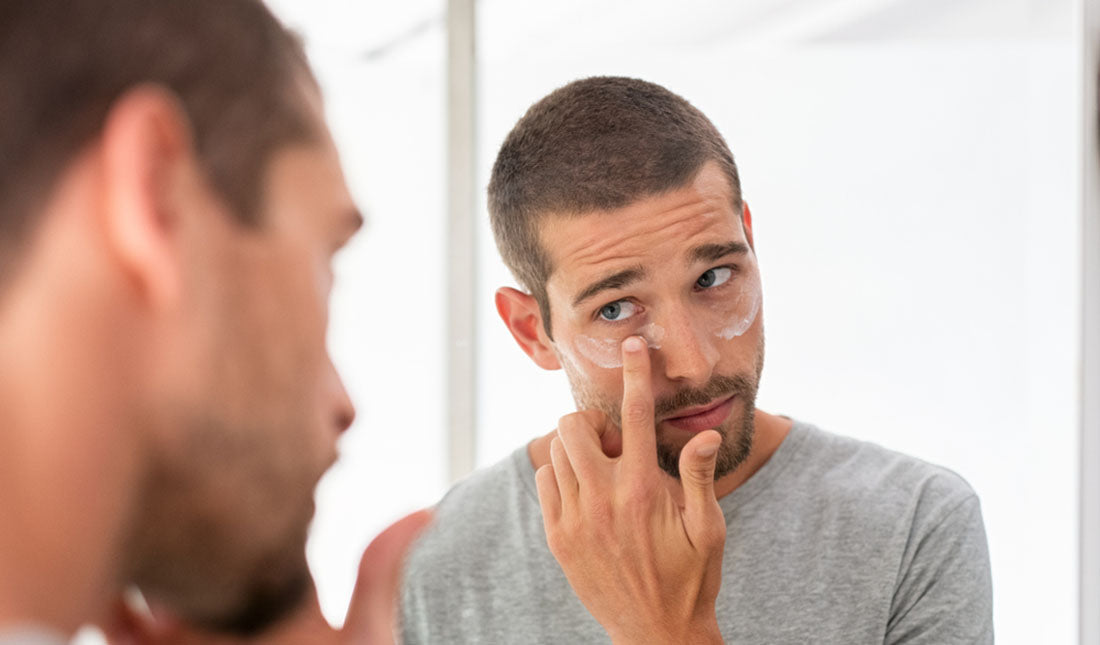 applying cream under eyes