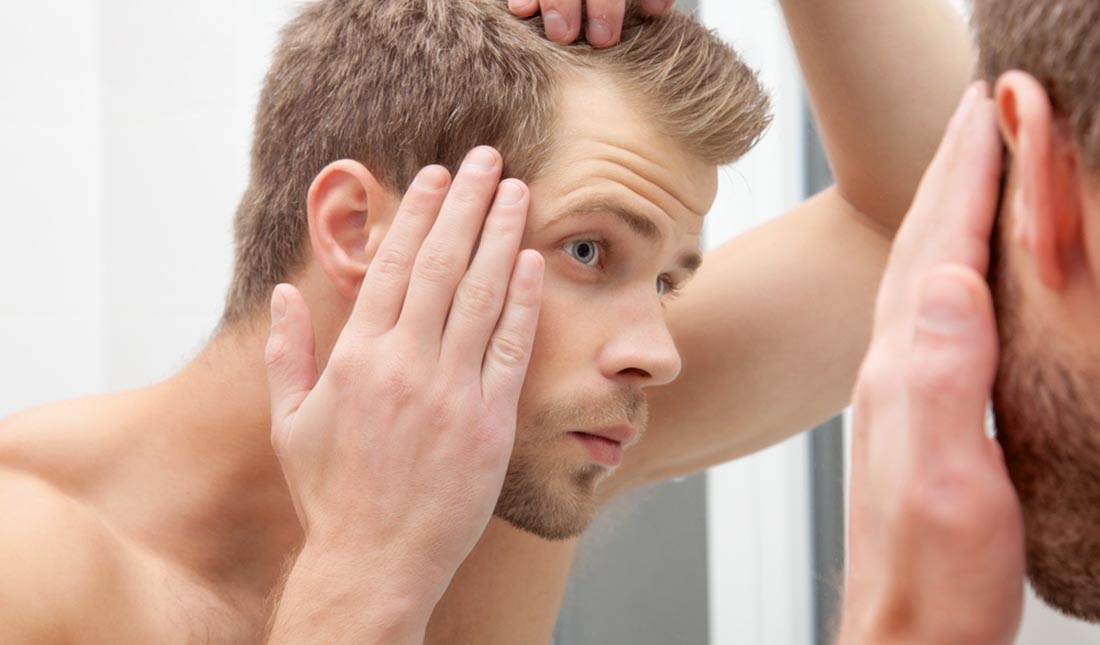 checking scalp in mirror