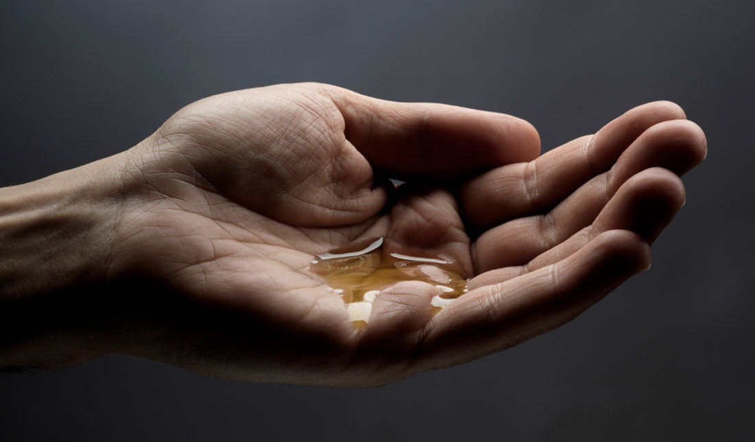 isolated hand with oil