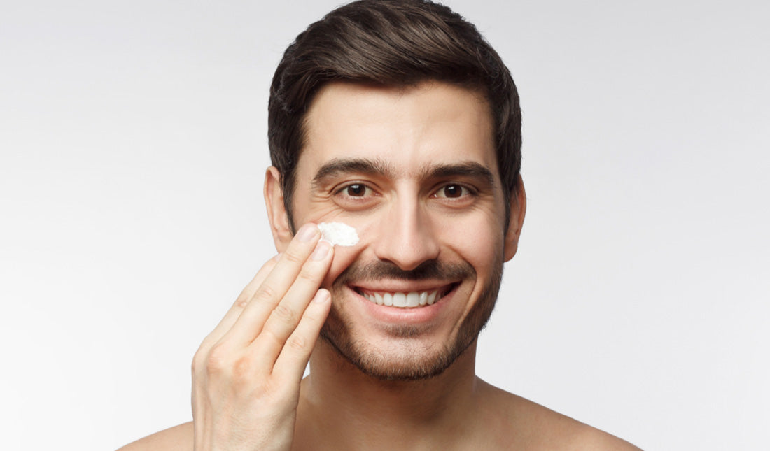 man applying facial cream