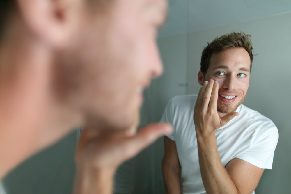 man applying facial cream