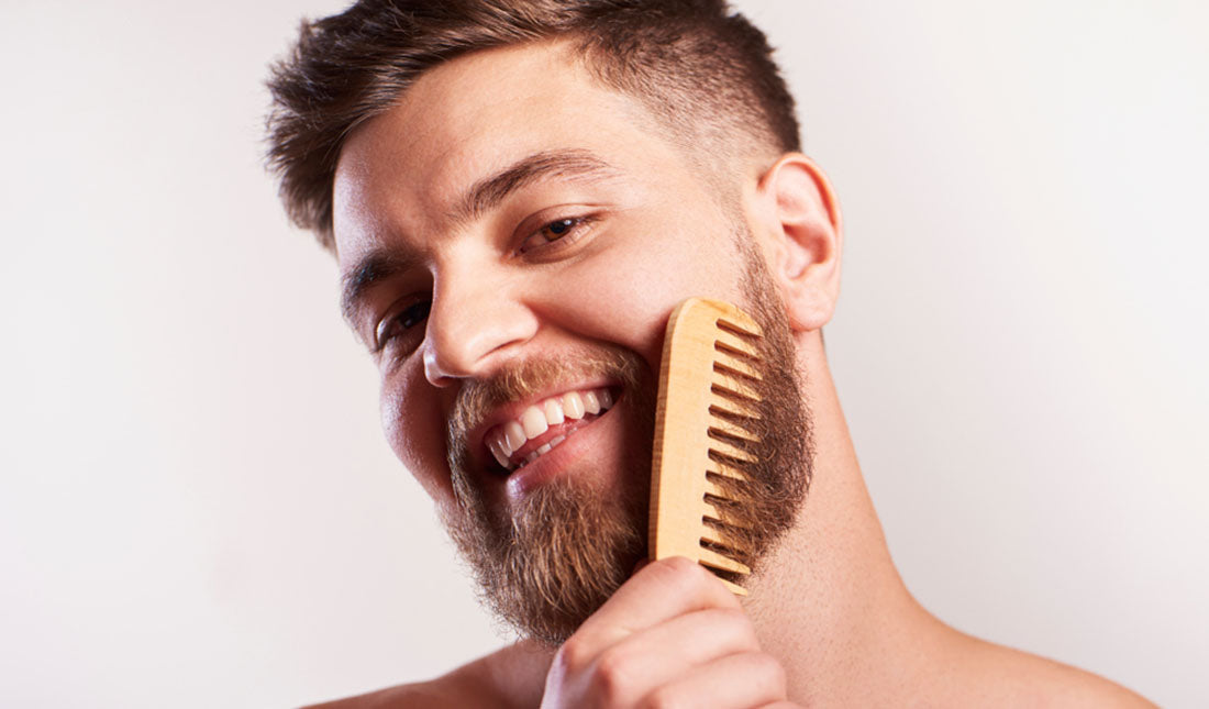 man combing beard