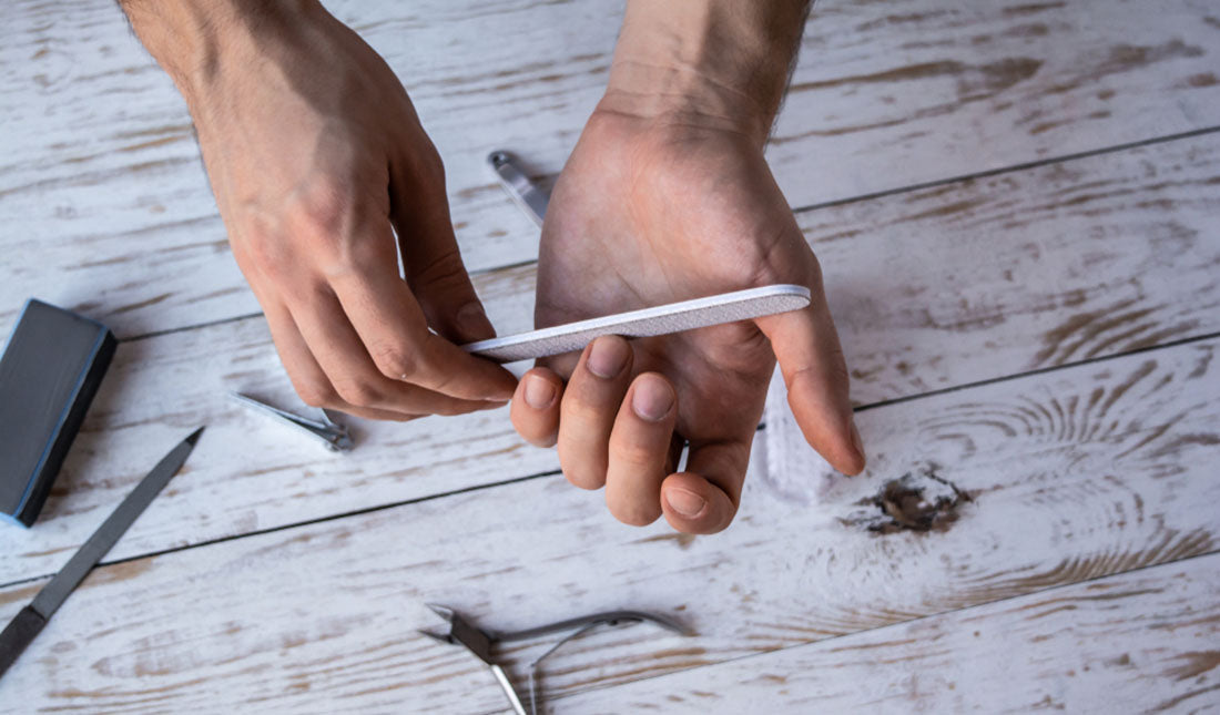 man filing nails