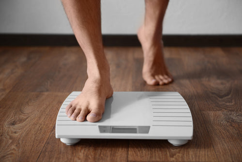 man standing on weight scale