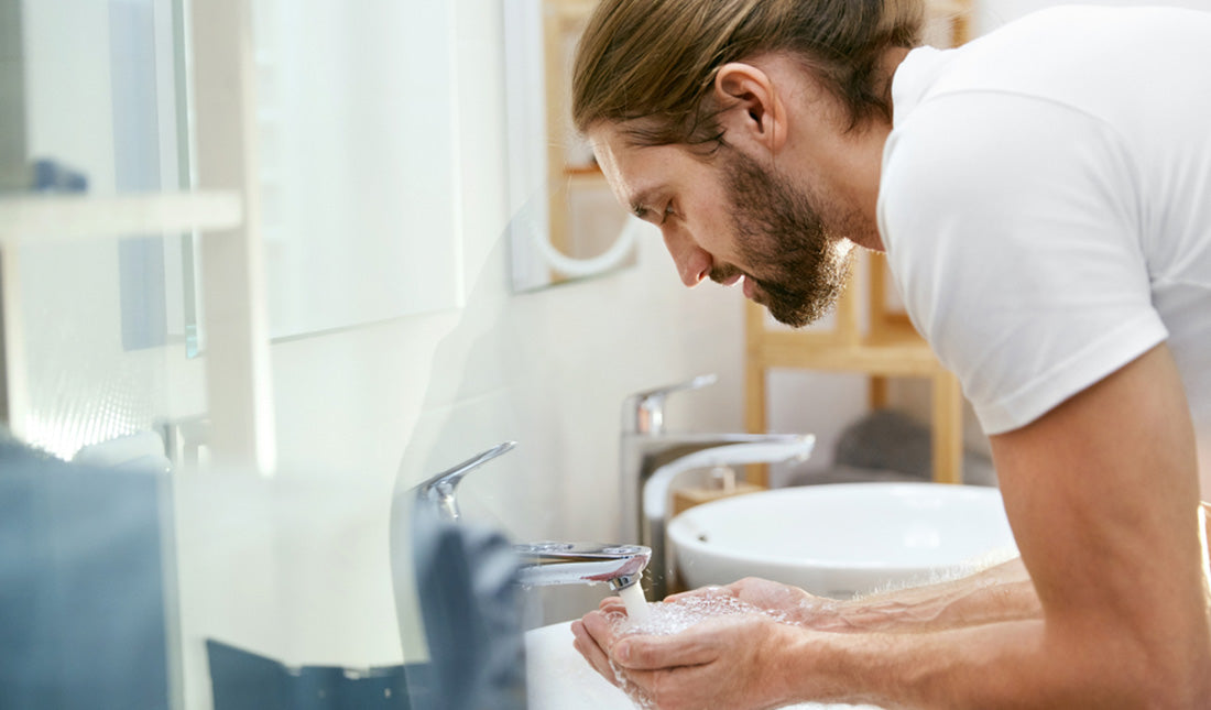 man washing face