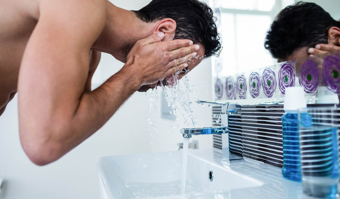 man washing his face