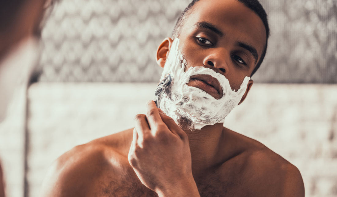 shaving face with cream and razor