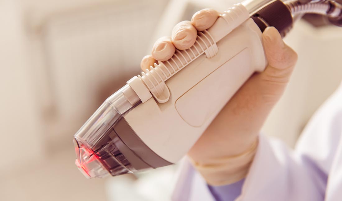 dermatologist holding skin treatment device