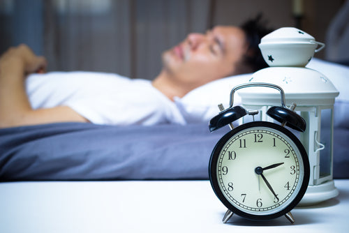 sleeping man with alarm clock