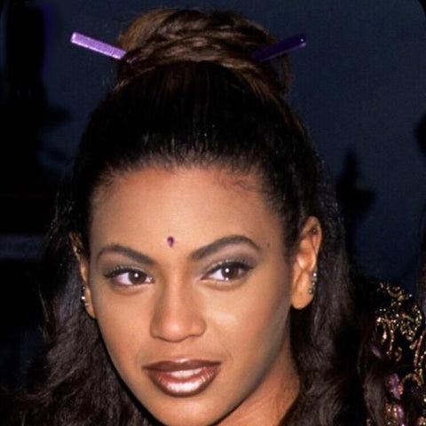 Beyonce circa 1999 wears a hair stick bun