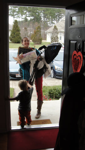 photographer holding equipment on the way out the door to a photoshoot