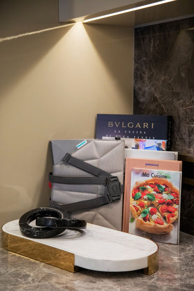 Folded Booster Seat stored together with cookbooks in the kitchen