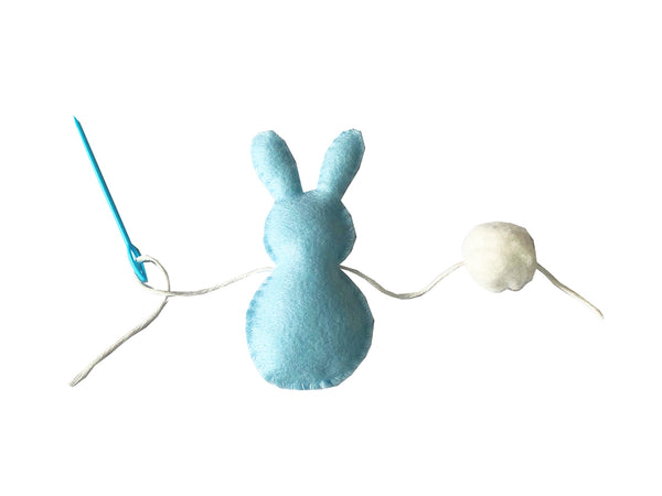 Thread the Easter Bunnies and Pom Poms onto string
