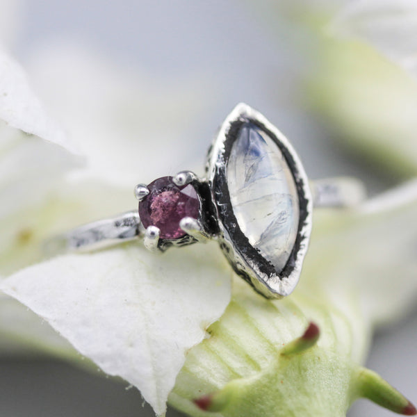 Marquise moonstone ring with pink tourmaline side set gems in bezel and prongs setting