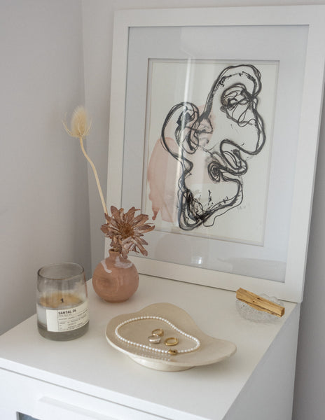 bedside table with a candle and dried flowers