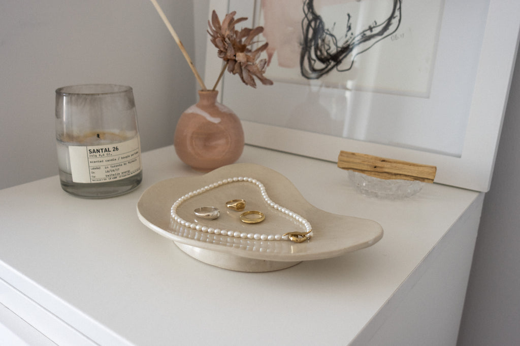 a small array of jewelry on an organic plate