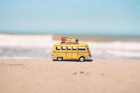 little yellow bus on beach - toucca kids top 10 must haves with kids travel