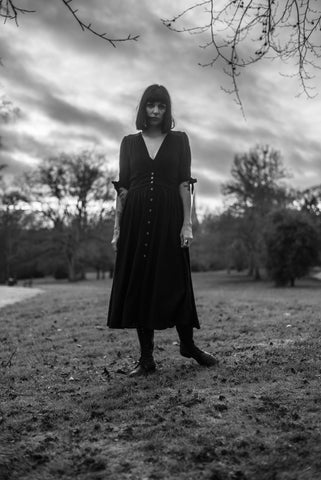Standing in the Shadows - dark figure on a horizon against ominous skies
