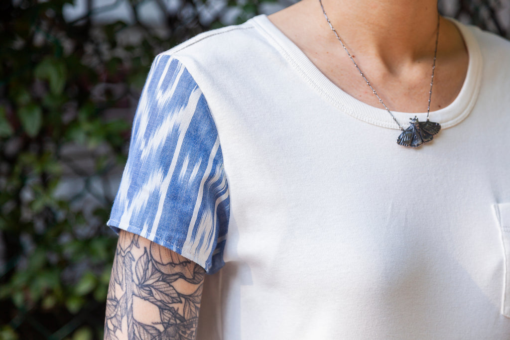 close up of a blue patterned short sleeve on a white shirt