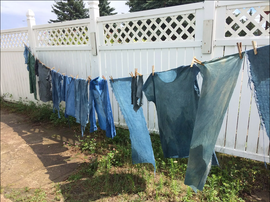 indgo dyed clothing drying on a line in the sun