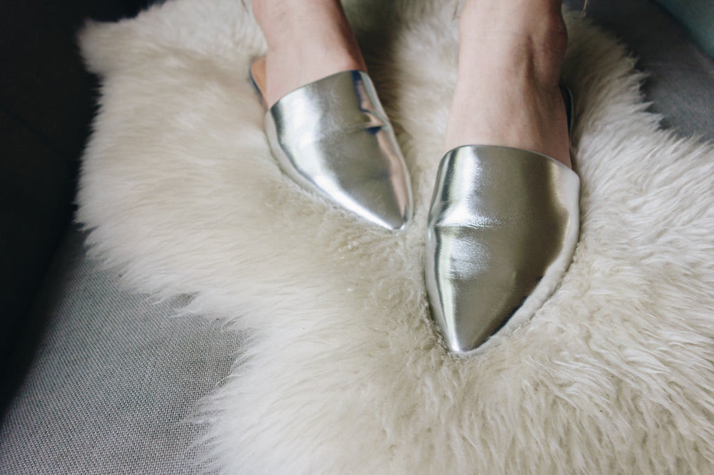 silver slipper mules on lambskin rug on model