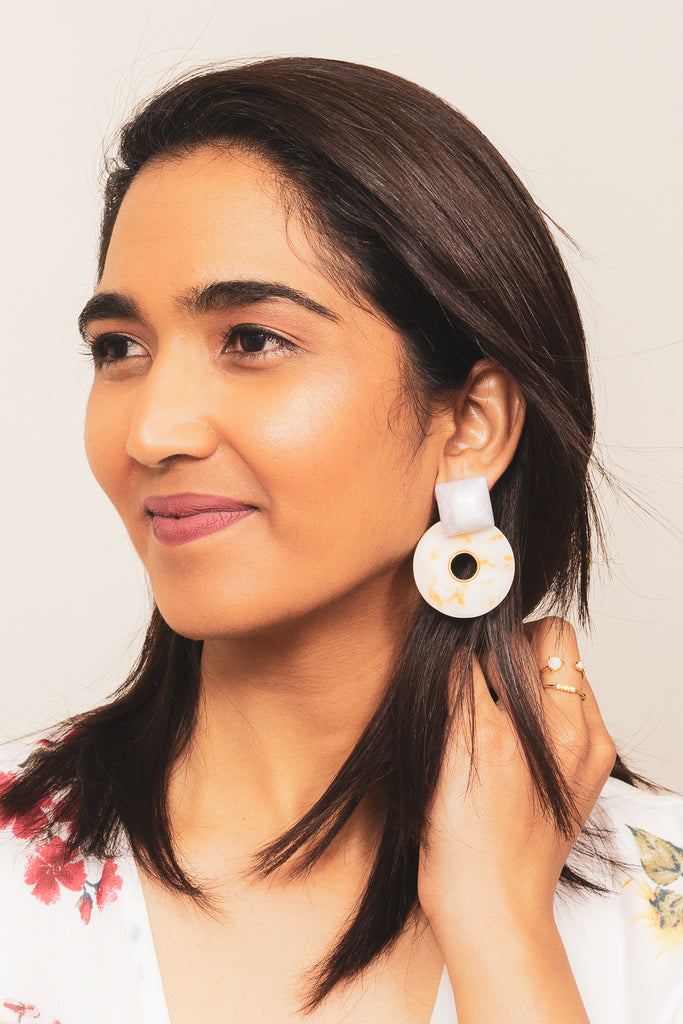 yellow and white acrylic statement earrings on model