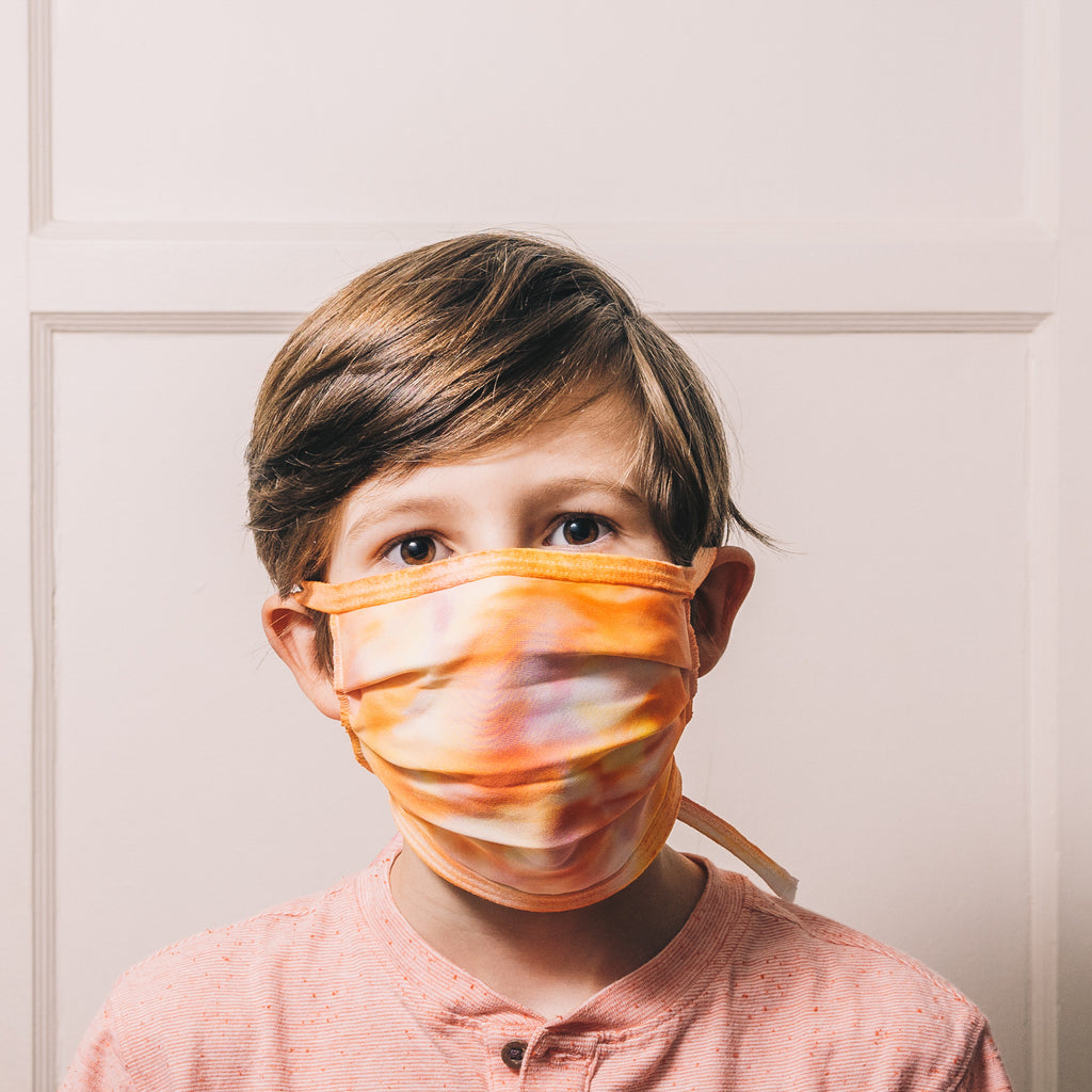 orange tie dye face mask on boy
