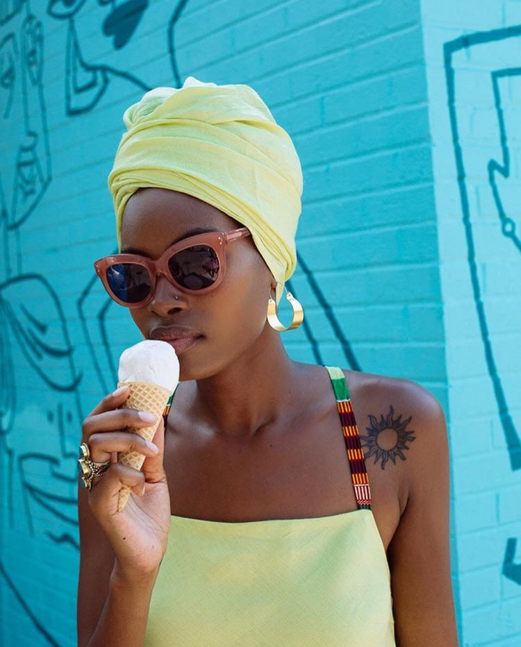 girl in lime head wrap and dress with ice cream cone sunglasses and hoop earrings