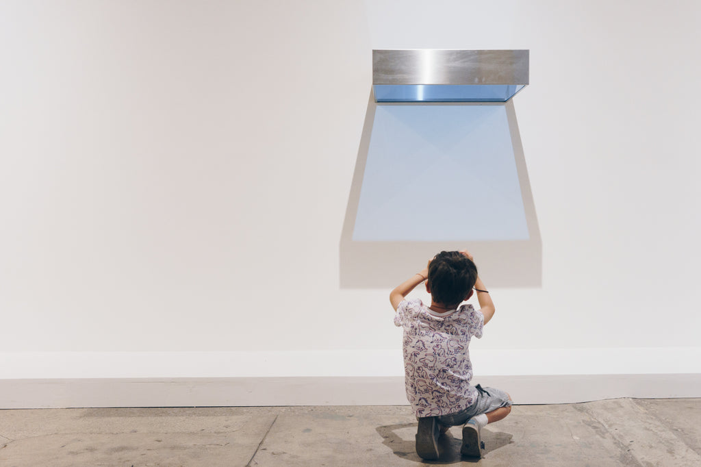 child taking photograph of Donald Judd artwork at Underground Museum LA