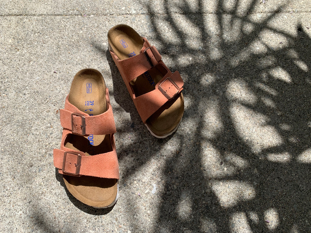 pink suede Birkenstocks with palm tree shadows