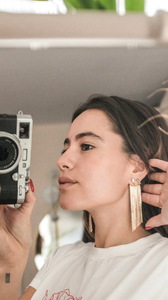 marquis fringe earrings on girl holding camera selfie