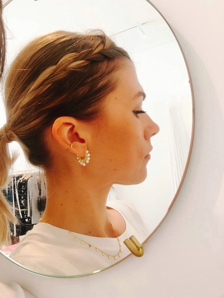 pearl huggie hoop earrings on model janna Conner
