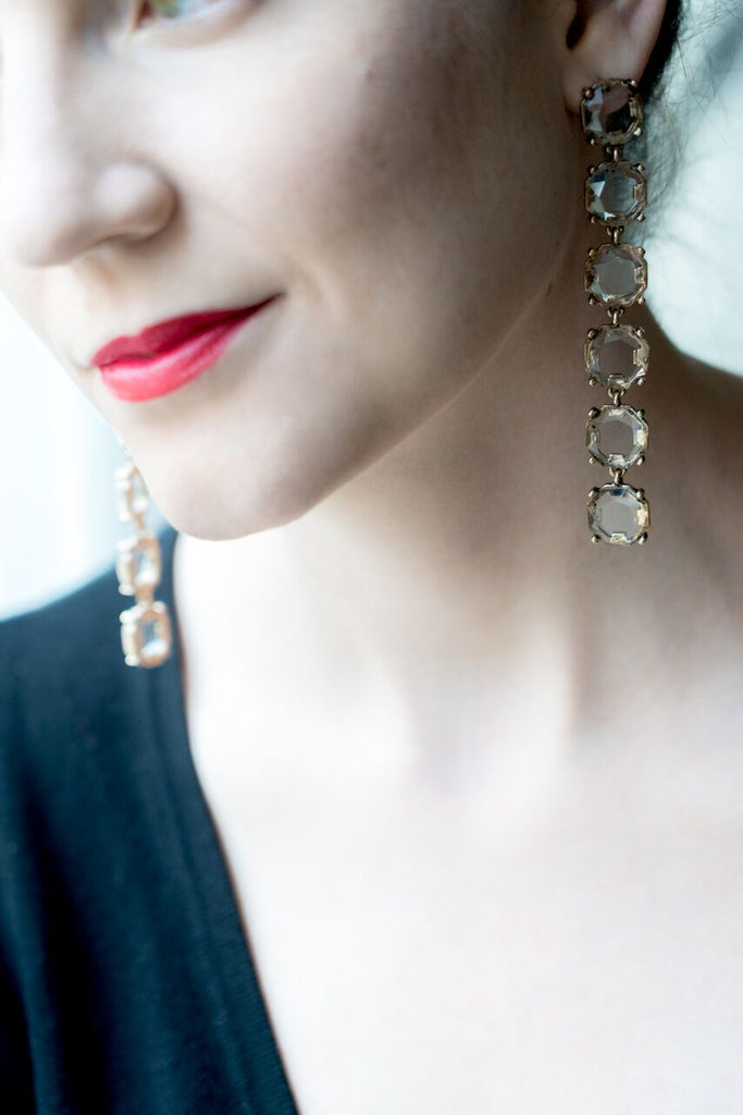 model wearing long shoulder duster crystal drop earrings with red lipstick