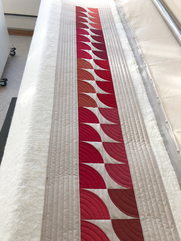 Long arm quilting of quilted table runner with Oakshott Fabrics Ruby Red bundle of shot cottons