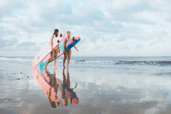 haikini two girls with surf boards
