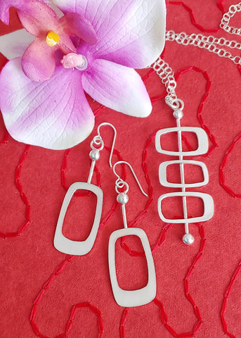 Set of Googie style sterling silver earrings and necklace