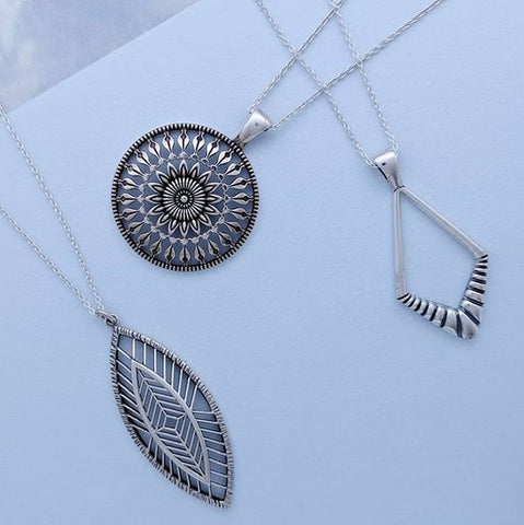 Christine Alaniz Designs - Magnolia Leaf, Protea Amulet, and Darkling Diamond Necklaces in sterling silver
