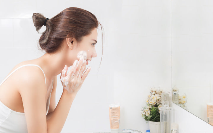 woman exfoliating her face