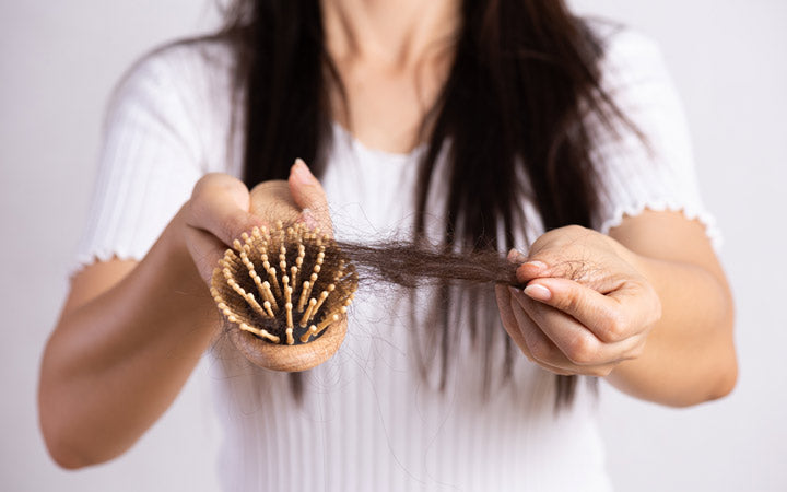 woman showing hair loss