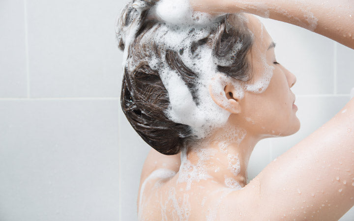 Woman shampooing to scalp
