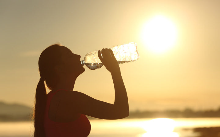 Woman drinking water to get hydrated