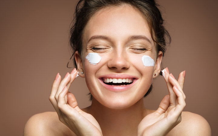  Woman apply moisturizer with happy face