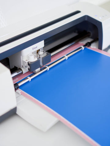 Kassa blue adhesive vinyl sheet being prepped in cricut cutting machine