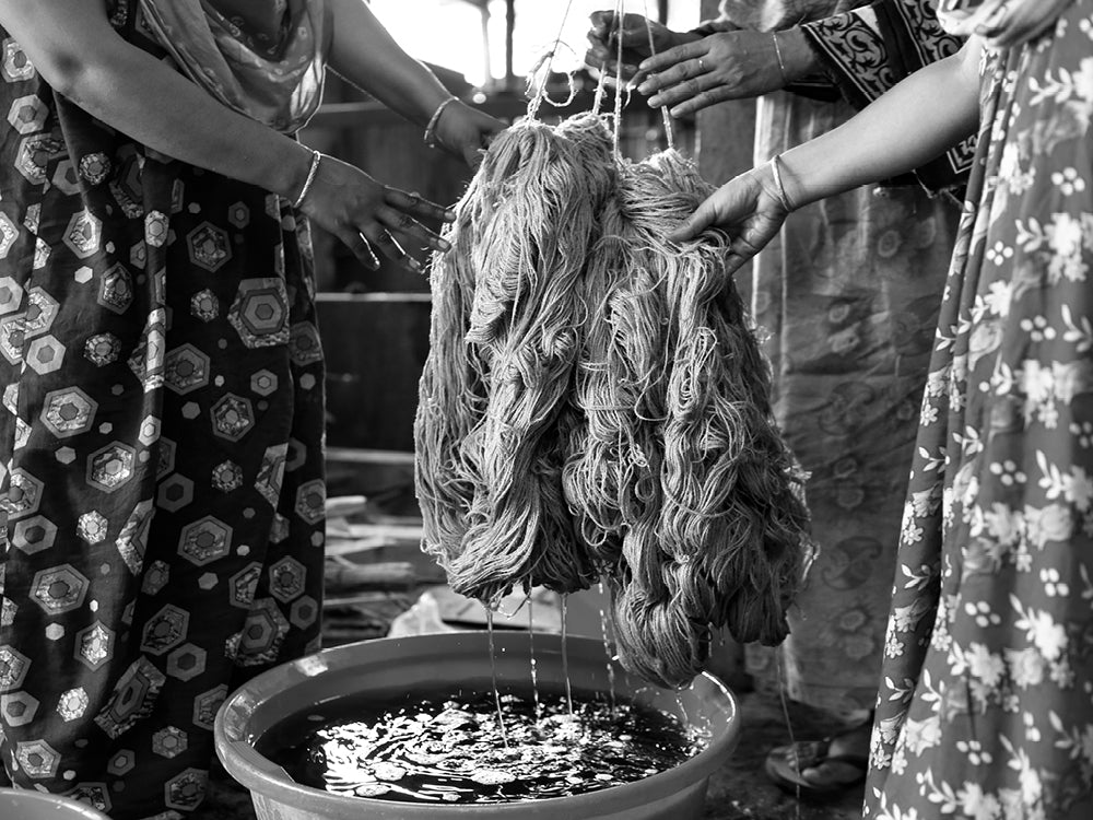 Fair trade artisans drying out wet fibres to be hand twisted ready for creating new products.