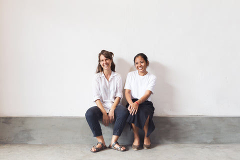 two woman sitting smiling
