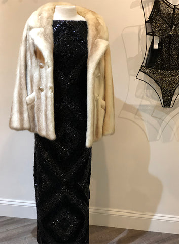 Vintage black wool dress with sequins and beads in diamond pattern, with light colored fur coat on top